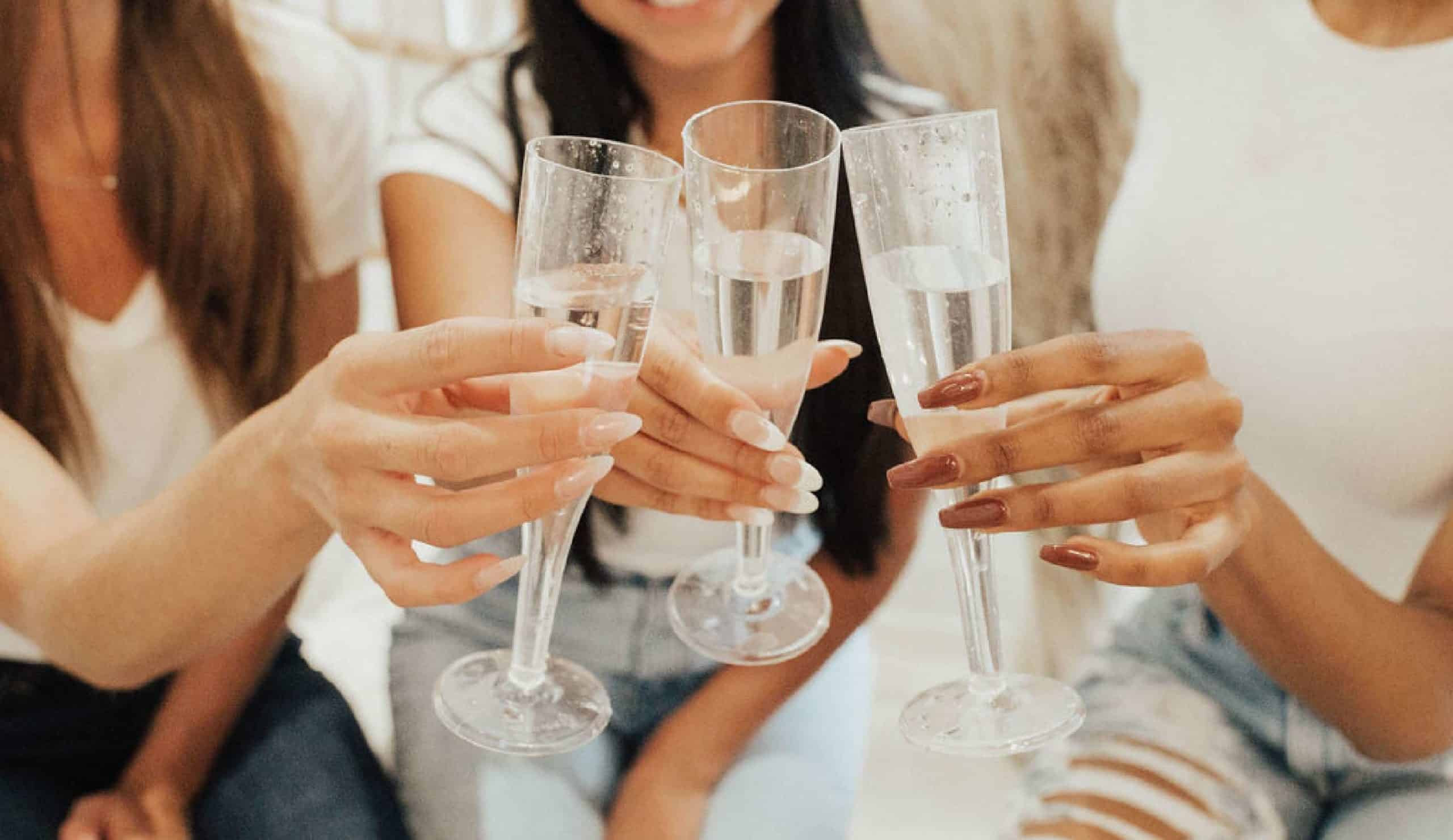 three champagne glasses cheering