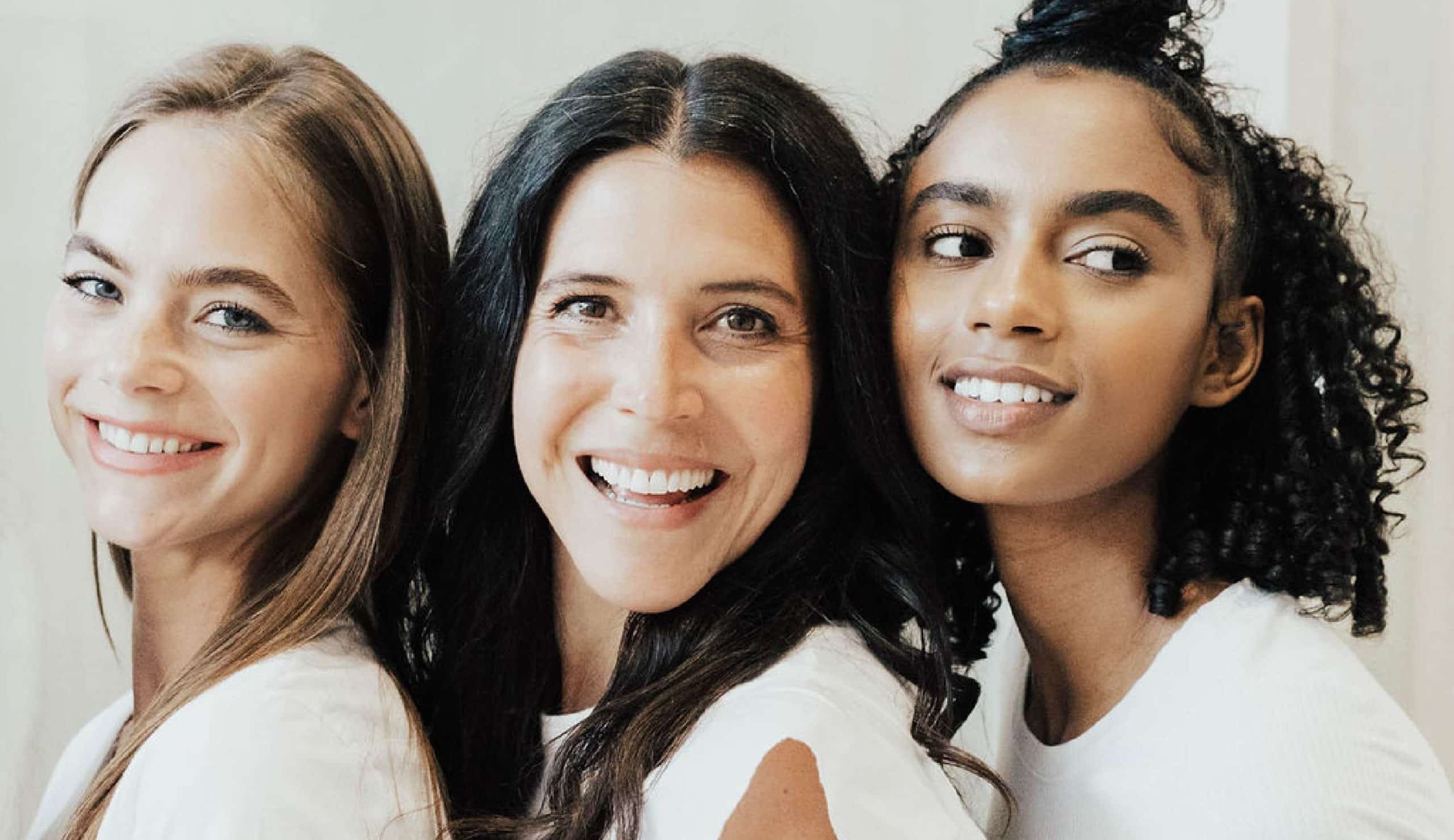 three women together, smiling at the camera